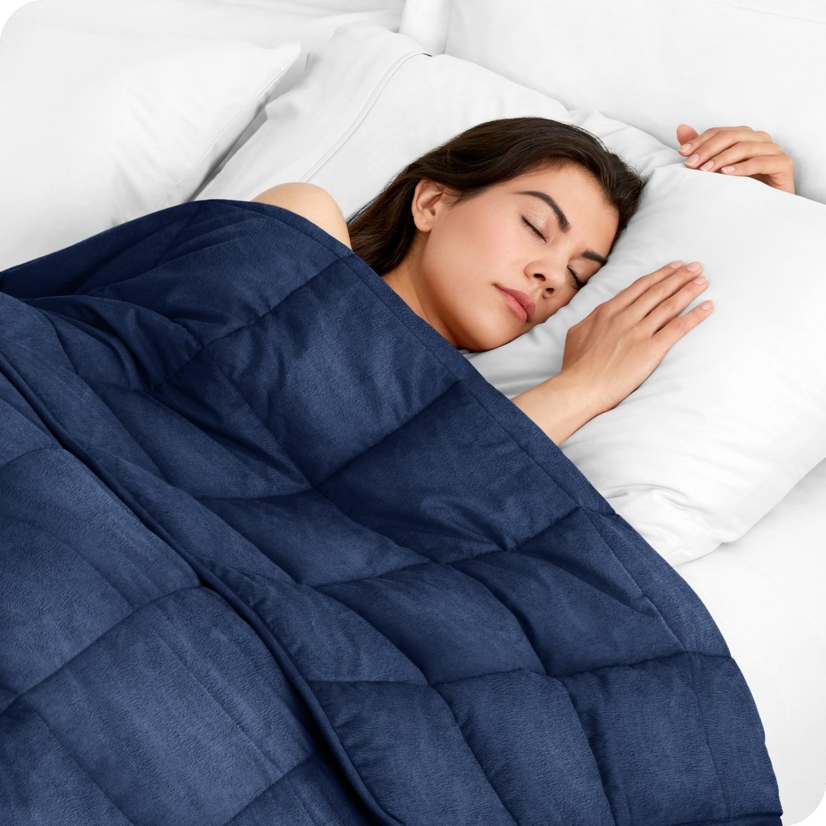 A woman sleeping with a weighted blanket over her body