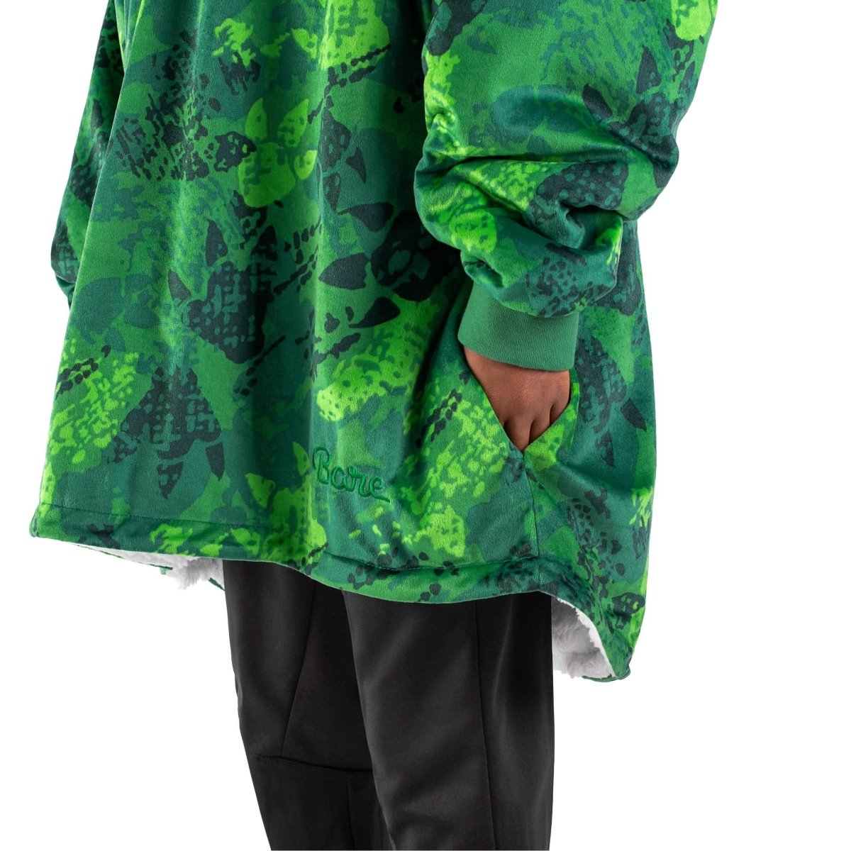 An adult with a sherpa wearable blanket on