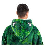 An adult with a sherpa wearable blanket on