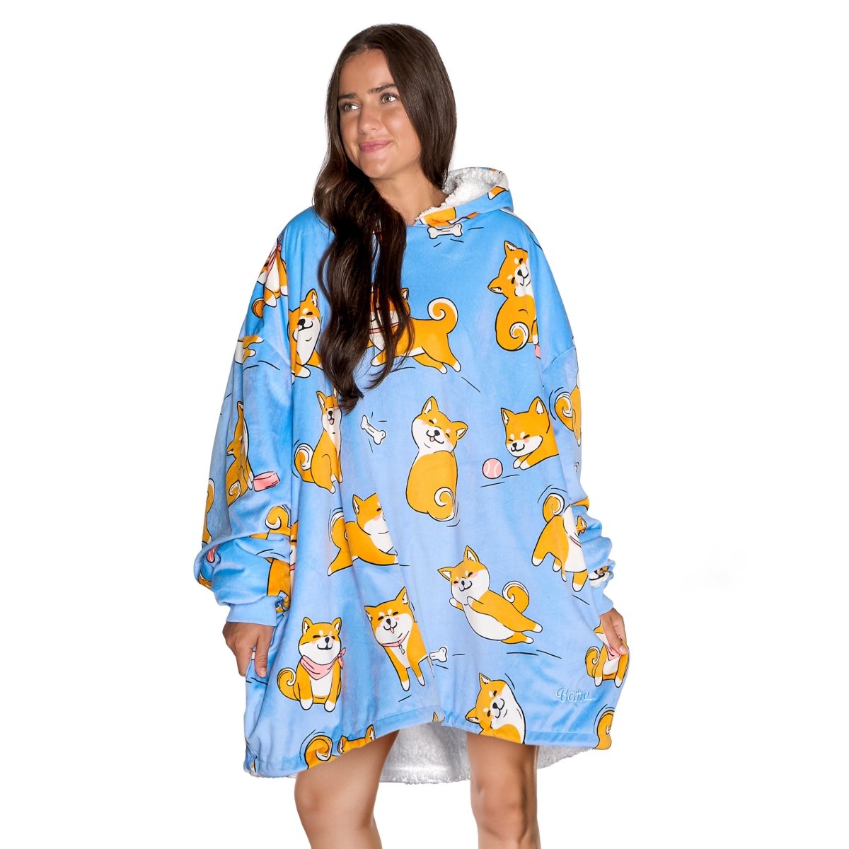 An adult with a sherpa wearable blanket on