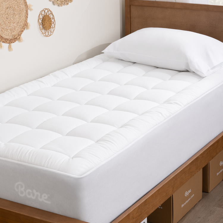 dorm bed with mattress protector on it