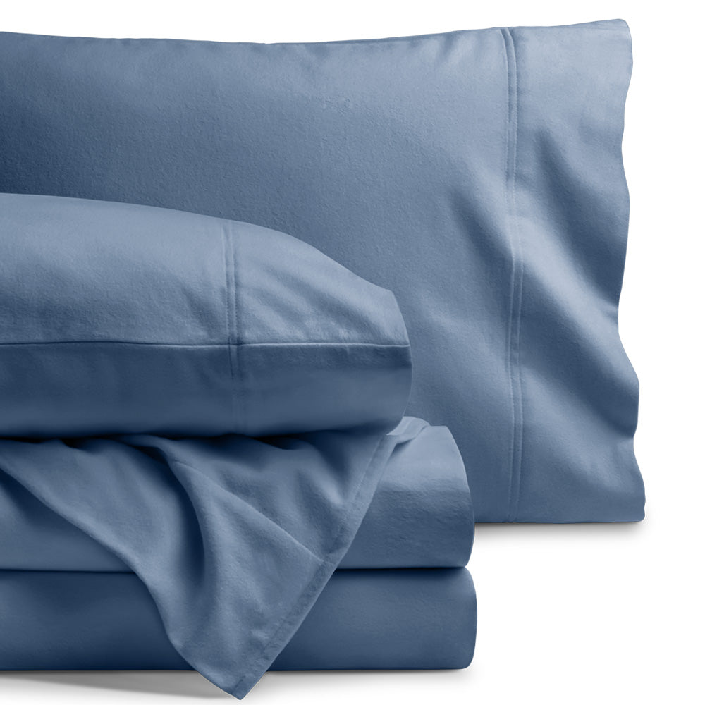 Blue flannel bed sheets and pillowcases set on a white background