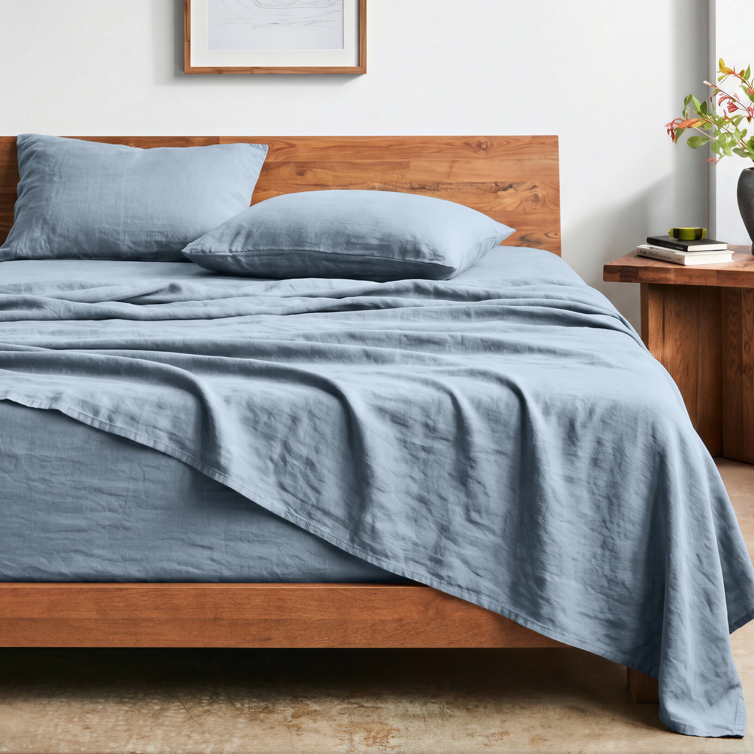 Bed with washed sheets and wooden headboard in a bedroom setting