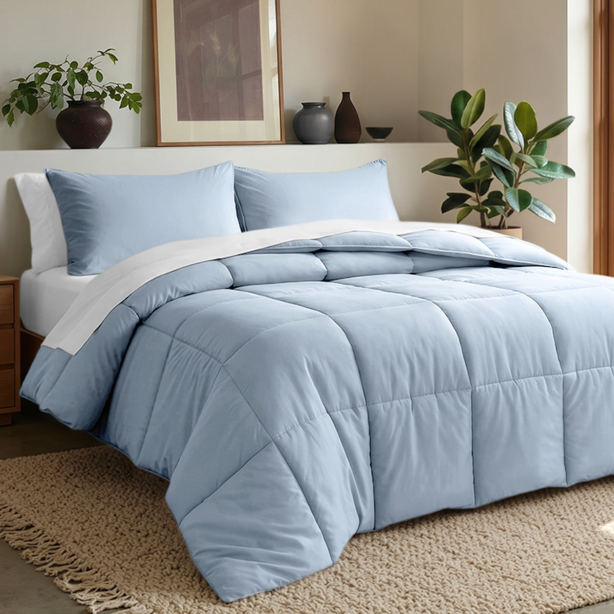 Comforter set on a bed in a bedroom with plants and decor.