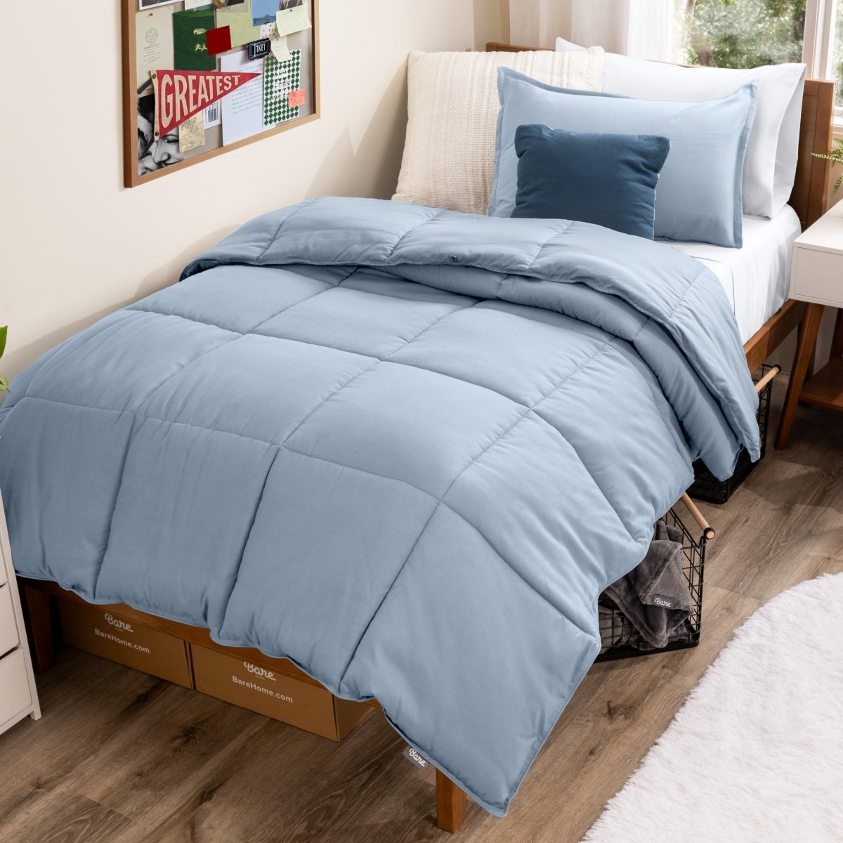 Bed with comforter and pillows in a dorm room