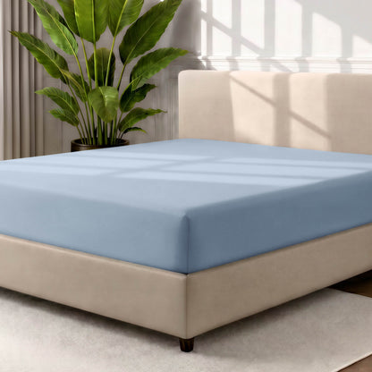 Ultra soft fitted sheet on a mattress with the sun shining into the bedroom