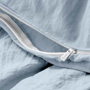 Close-up of a duvet cover with a zipper, featuring the brand Bare Home