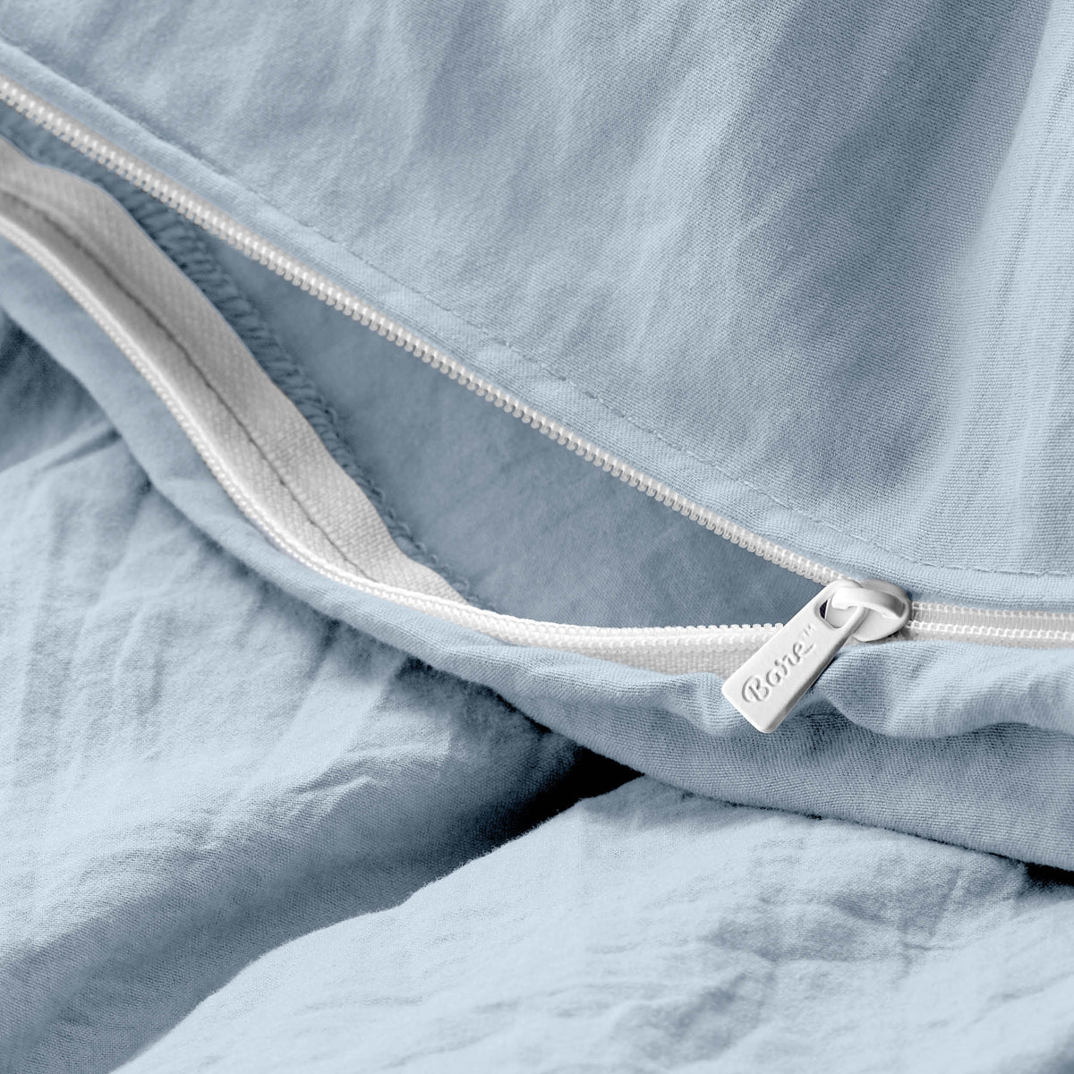 Close-up of a duvet cover with a zipper, featuring the brand Bare Home