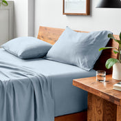 Bed with microfiber bedding and pillows in a bedroom setting