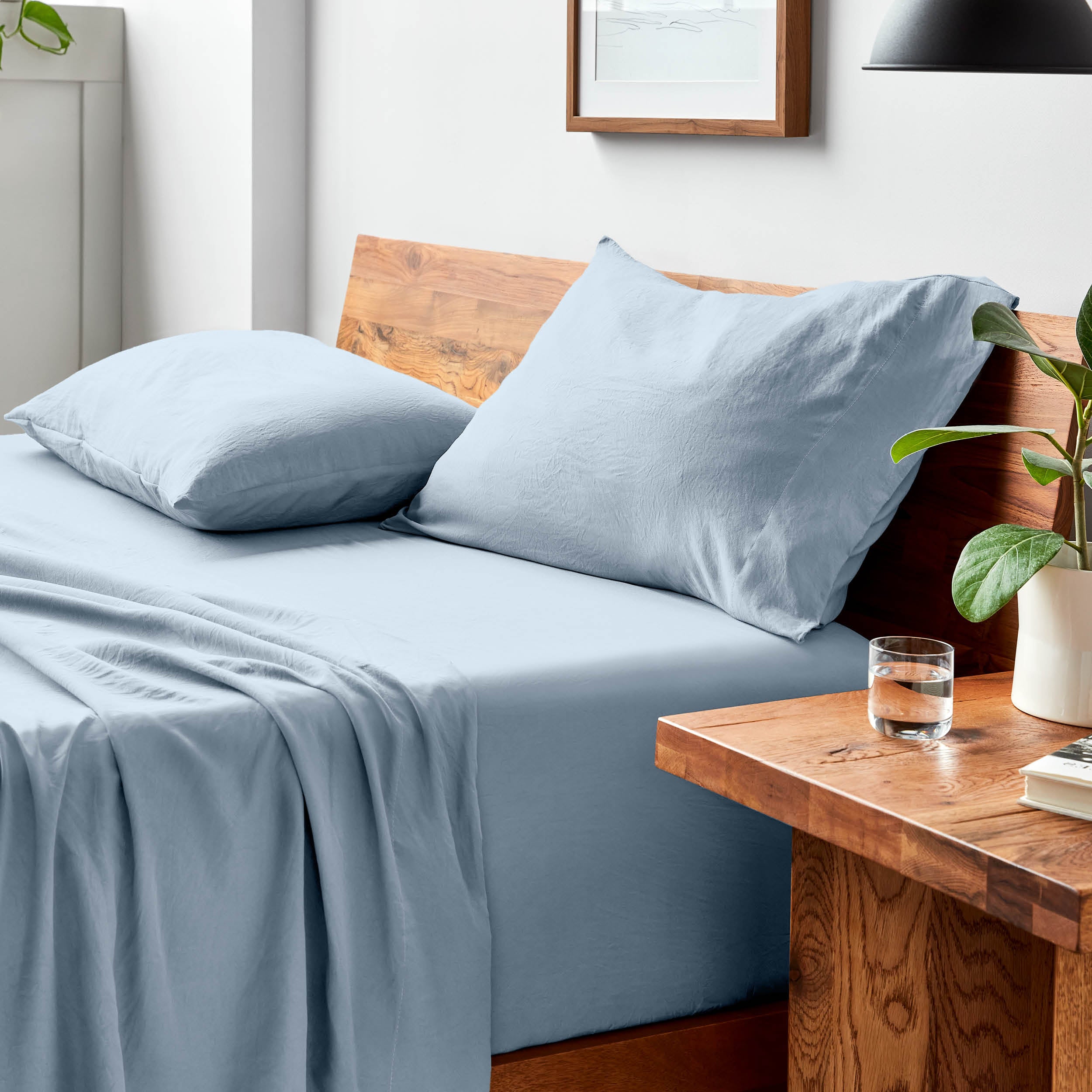 Bed with microfiber bedding and pillows in a bedroom setting