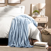 Microplush blanket draped over the corner of a bed