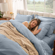 Woman sleeping on a bed made with percale sheets and duvet cover