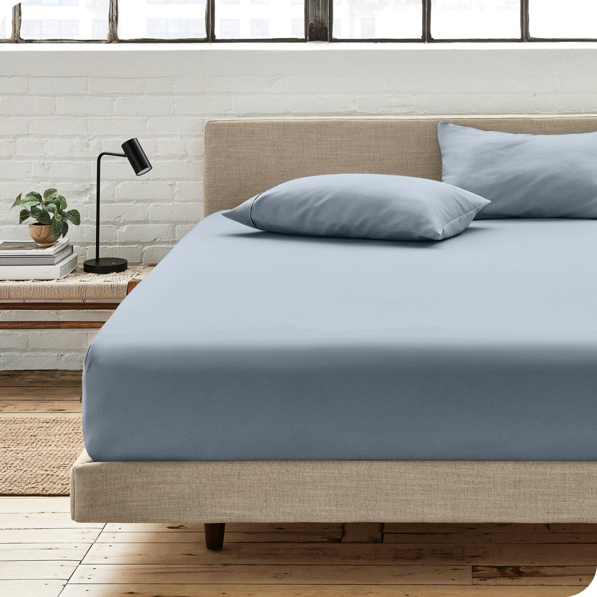 Bedroom scene with organic cotton fitted sheet and pillowcases on a bed