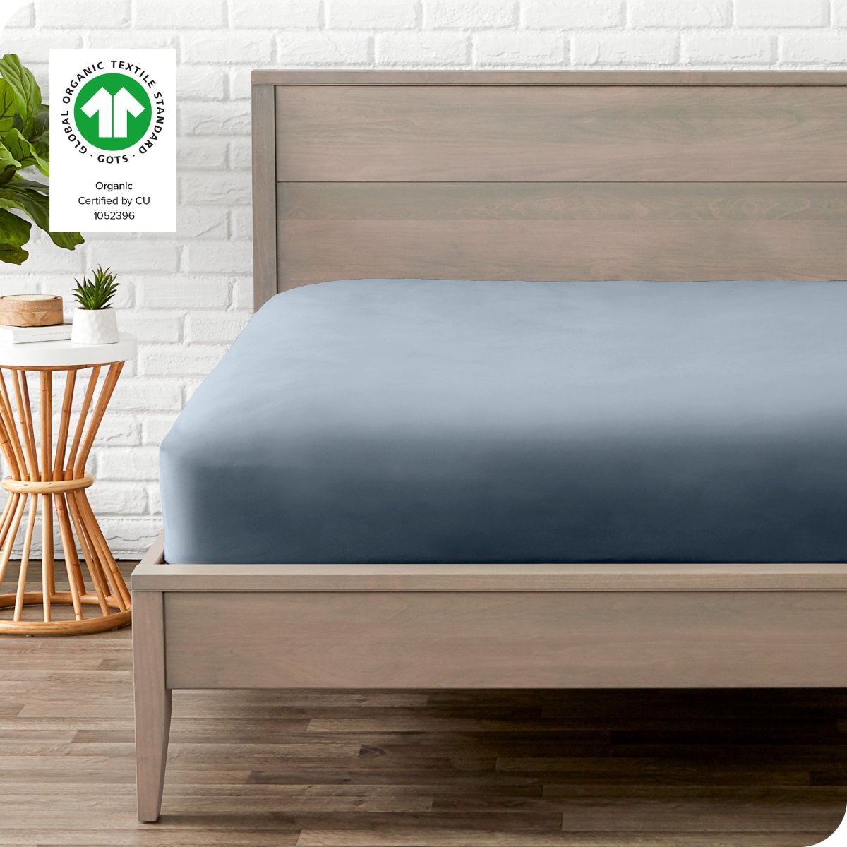 Modern wood bed frame with a sateen fitted sheet on the mattress