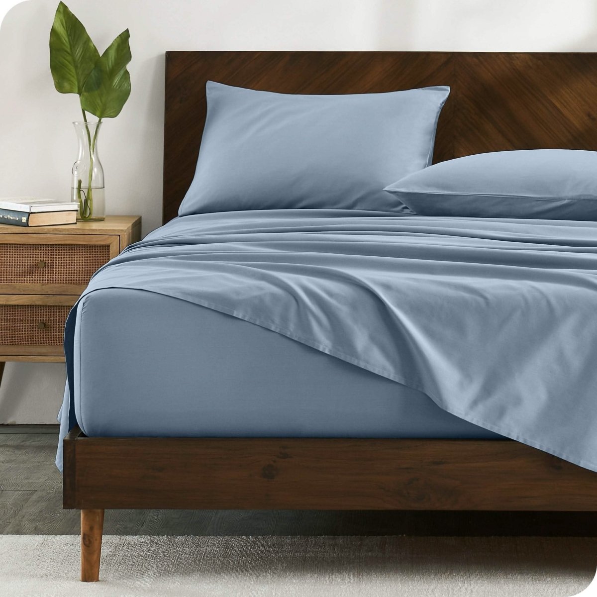 A bed made with organic cotton sateen sheets