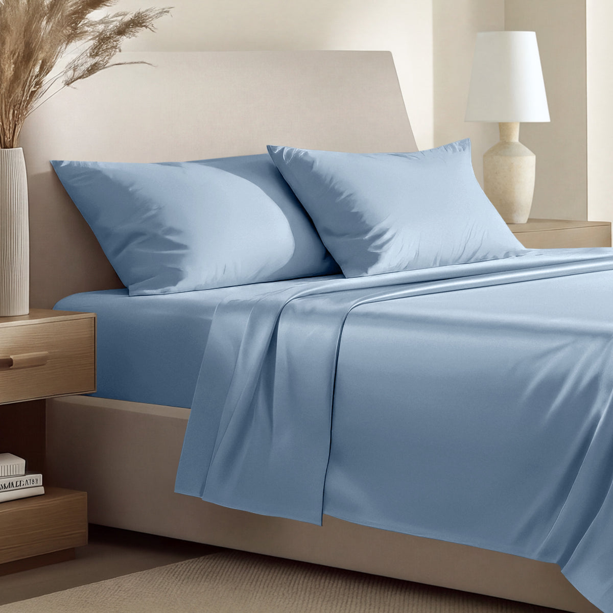 Sateen bedding set including a fitted sheet and two matching pillowcases on a bed.