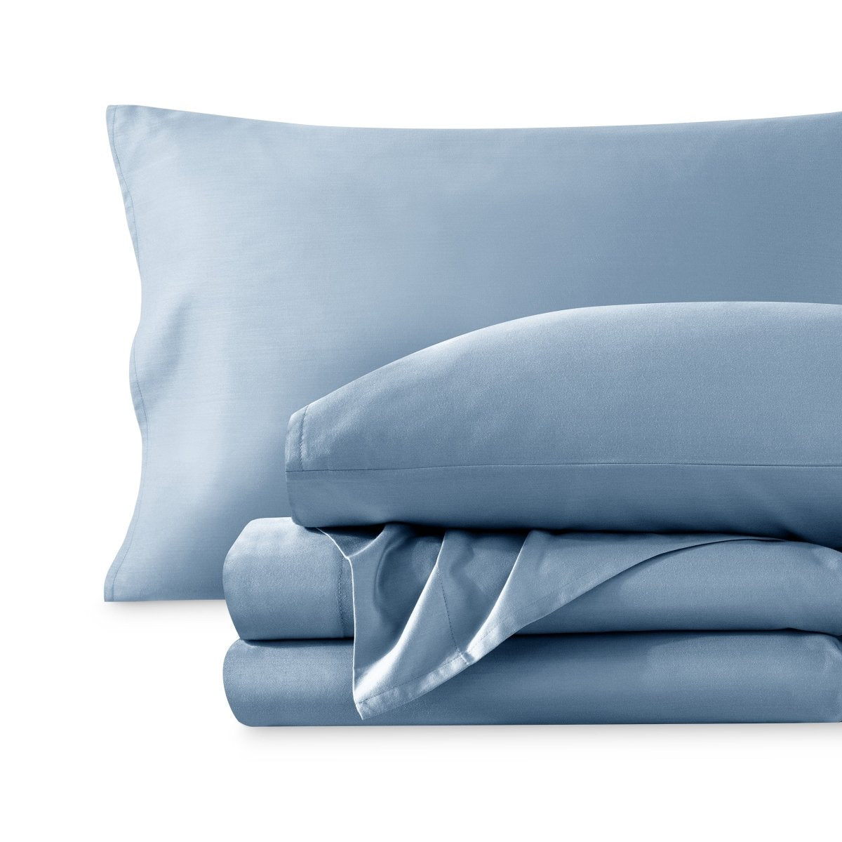 A sateen sheet set folded and stacked on a white background.