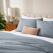 Bed with percale bedding in a bedroom setting
