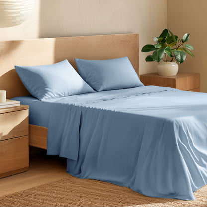 Bed with percale bedding and wooden headboard in a bedroom setting