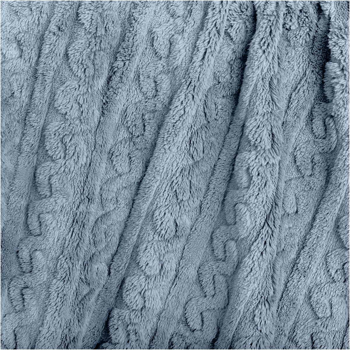 Close-up of a textured blanket with a cable knit pattern