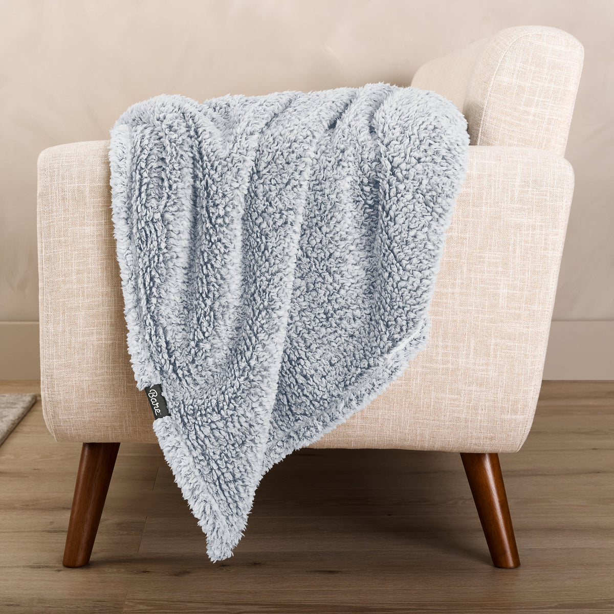 A textured blanket draped over a chair