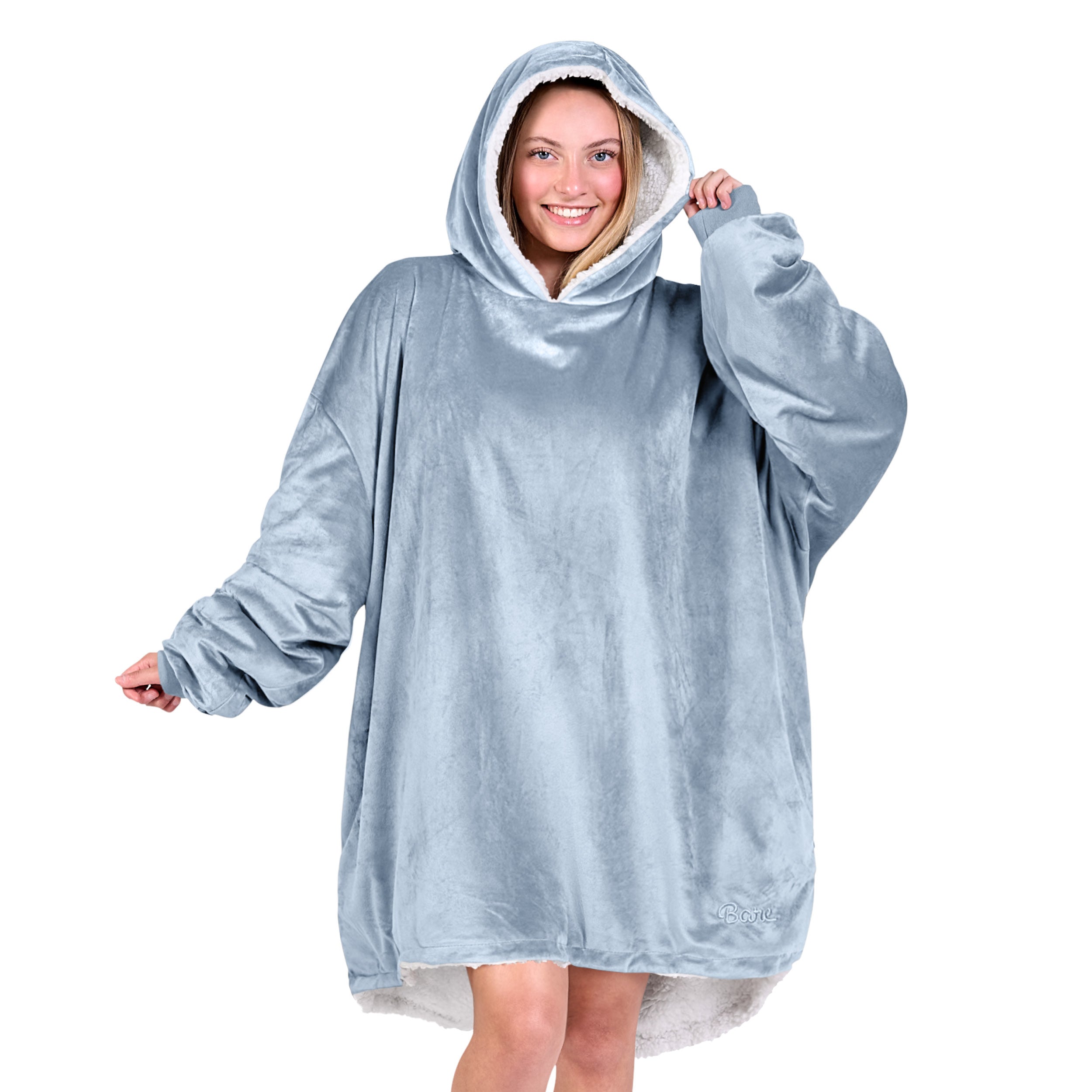 An adult with a sherpa wearable blanket on