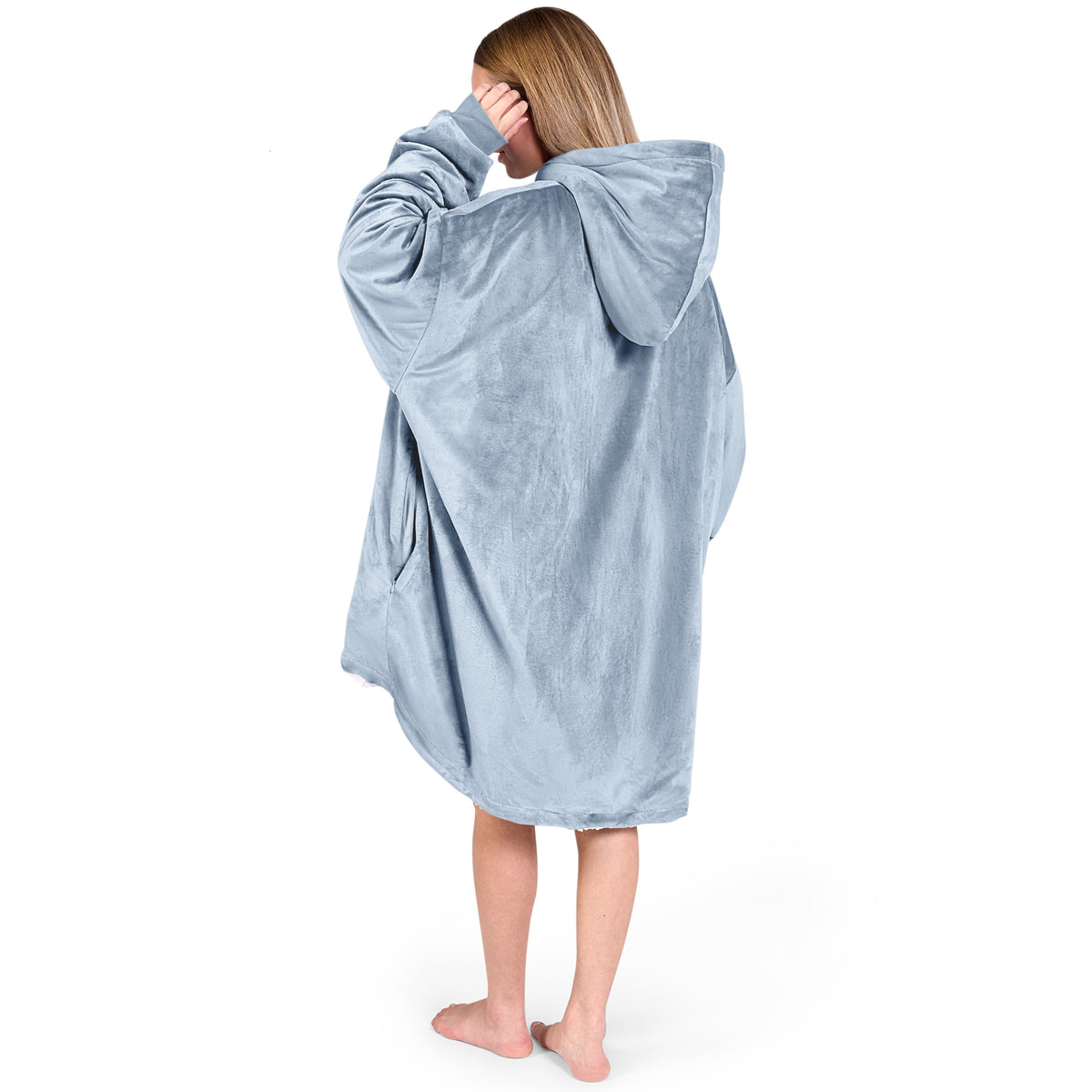 An adult with a hooded wearable blanket on