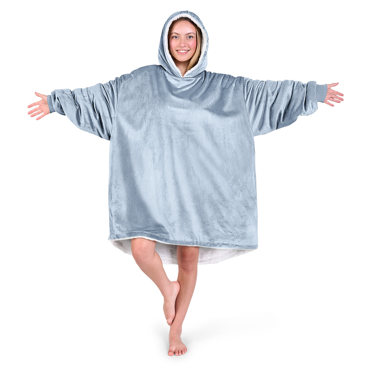 An adult with a sherpa wearable blanket on