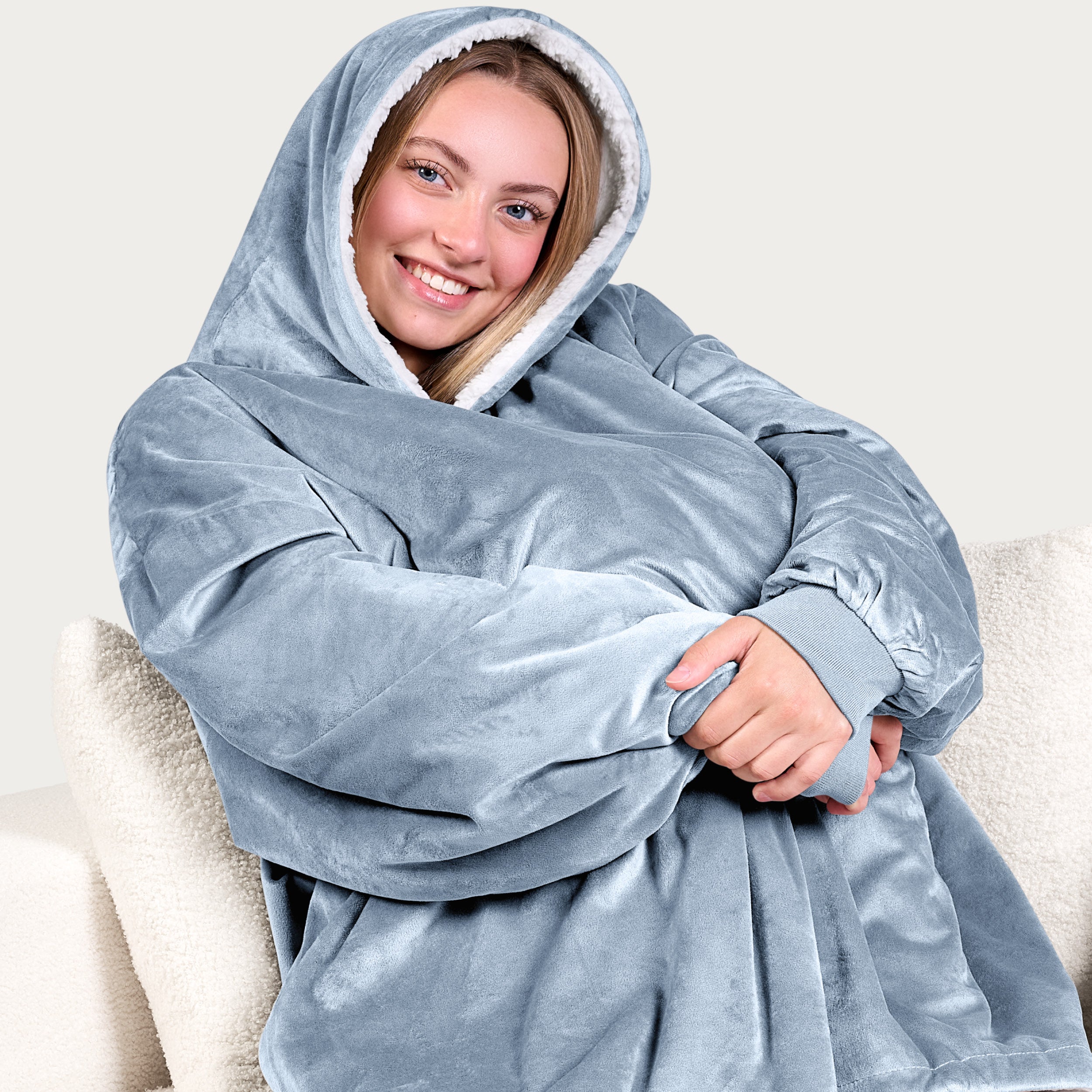 An adult with a sherpa wearable blanket on