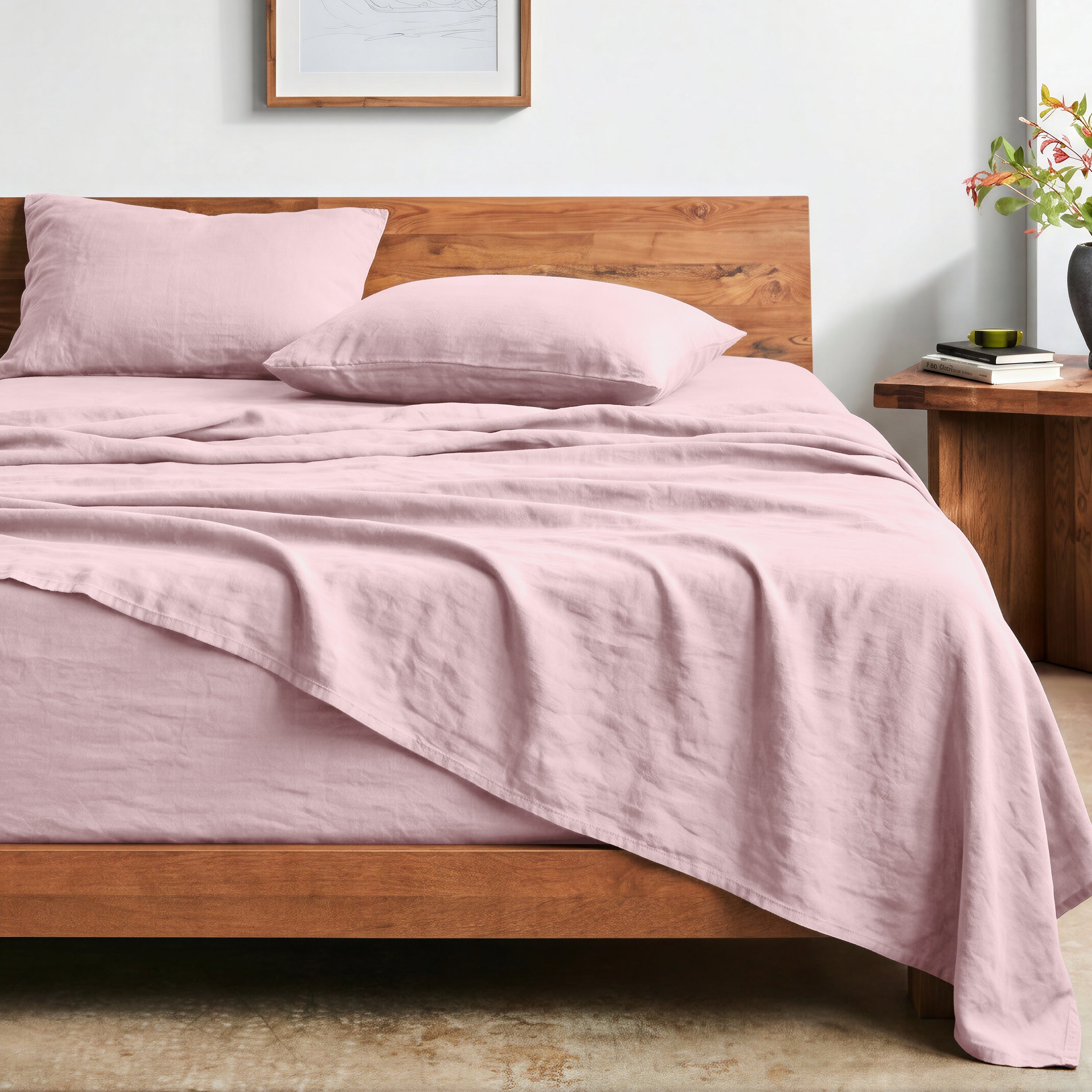 Bed with washed sheets and wooden headboard in a bedroom setting