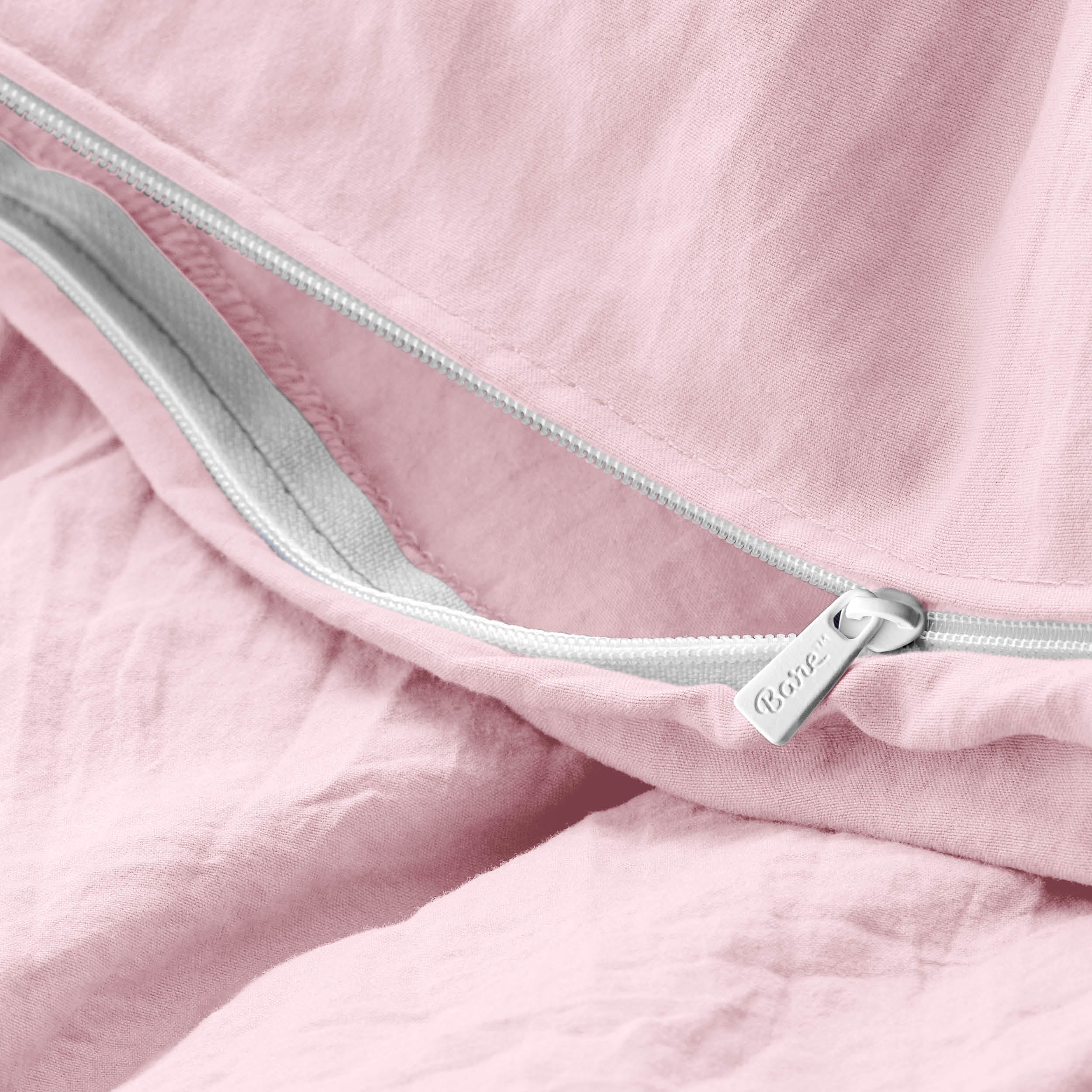 Close-up of a duvet cover with a zipper, featuring the brand Bare Home
