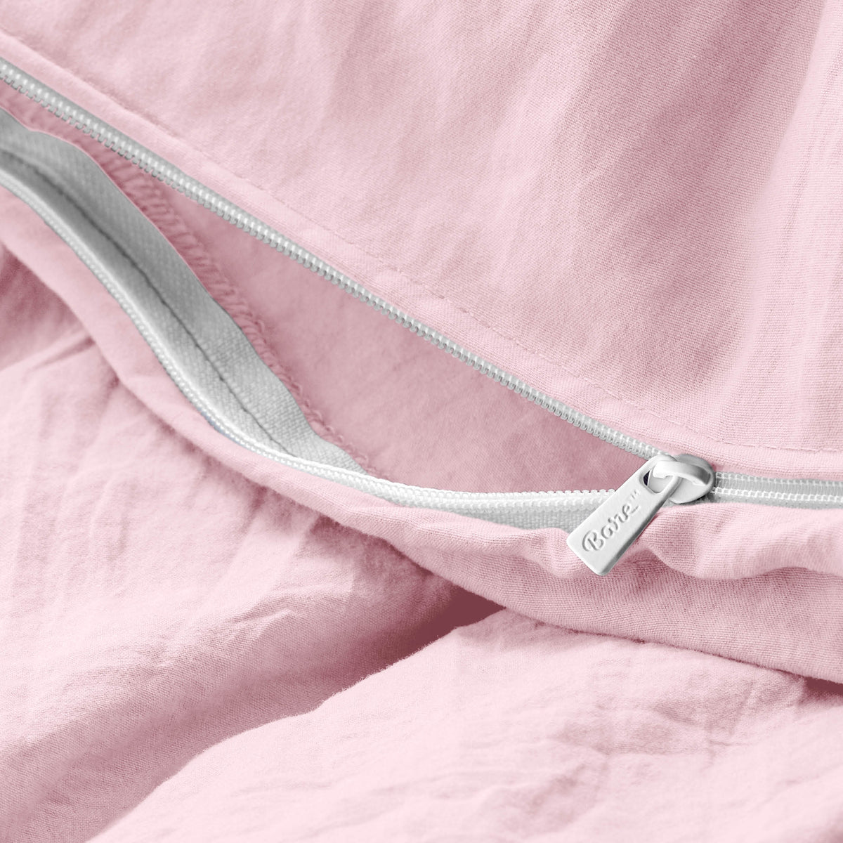 Close-up of a duvet cover with a zipper, featuring the brand Bare Home