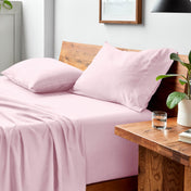 Bed with microfiber bedding and pillows in a bedroom setting