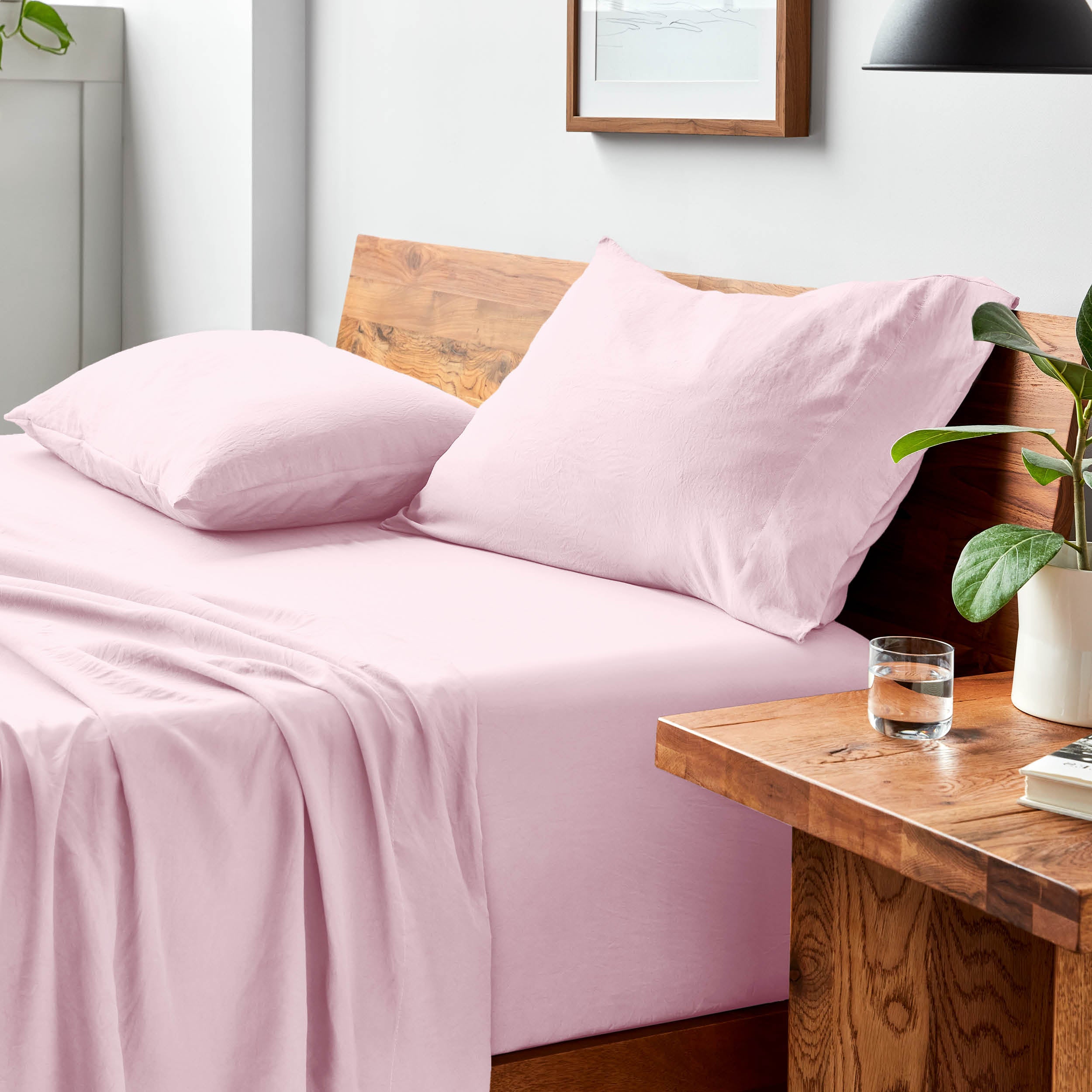 Bed with microfiber bedding and pillows in a bedroom setting
