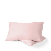 Two pillows with percale pillowcases on them
