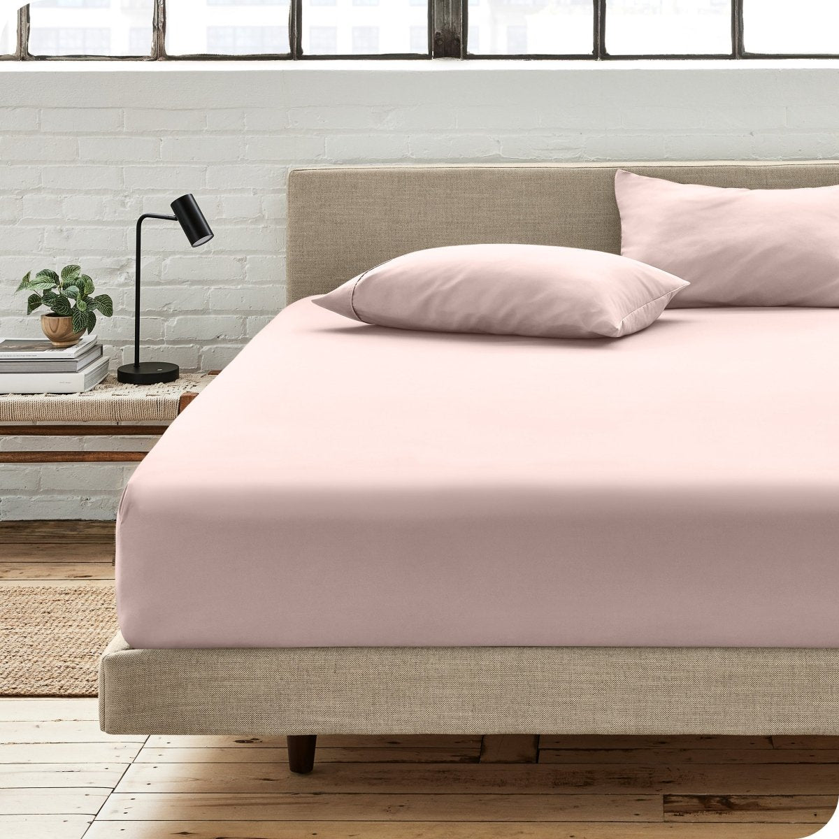 Bedroom scene with organic cotton fitted sheet and pillowcases on a bed