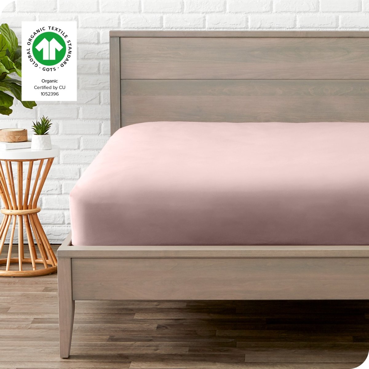 Modern wood bed frame with a sateen fitted sheet on the mattress