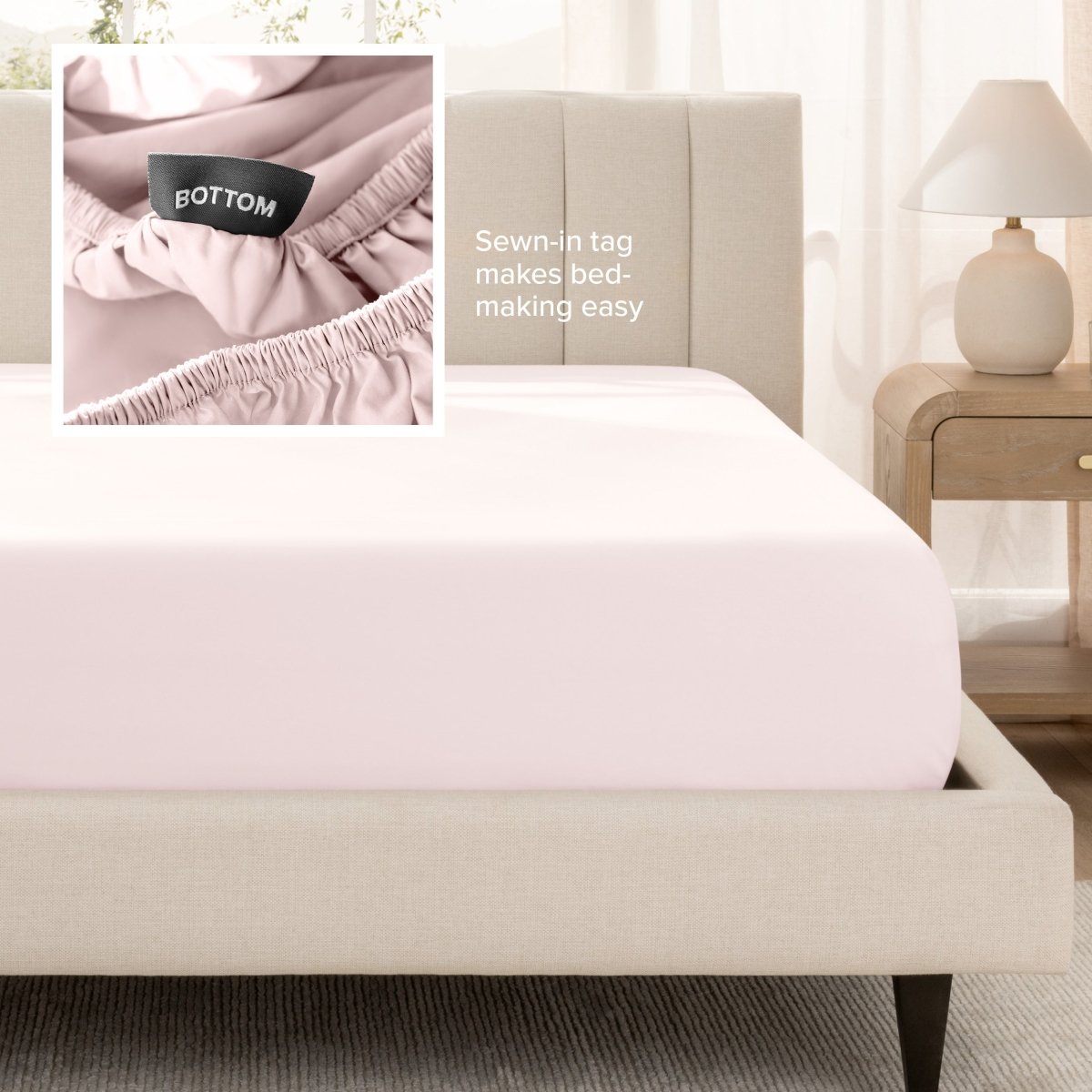 Sateen fitted sheet on a bed with a close-up of a sewn-in tag, set in a bedroom.