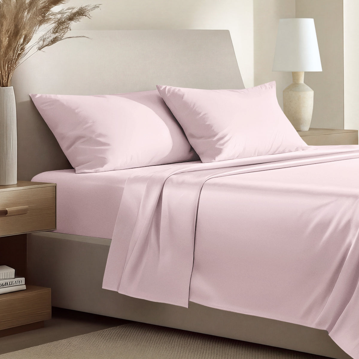 Sateen bedding set including a fitted sheet and two matching pillowcases on a bed.