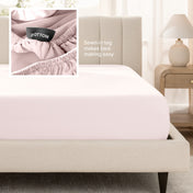 Bed with a fitted sheet next to a nightstand in a bedroom setting