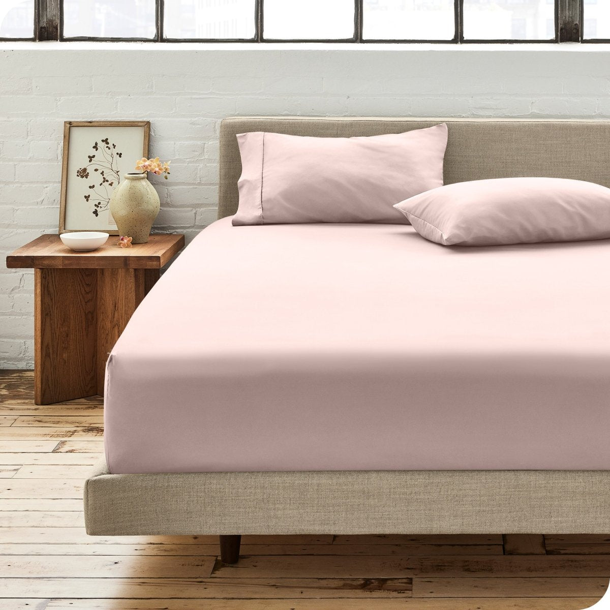 Modern bedroom with bed showing percale fitted sheet