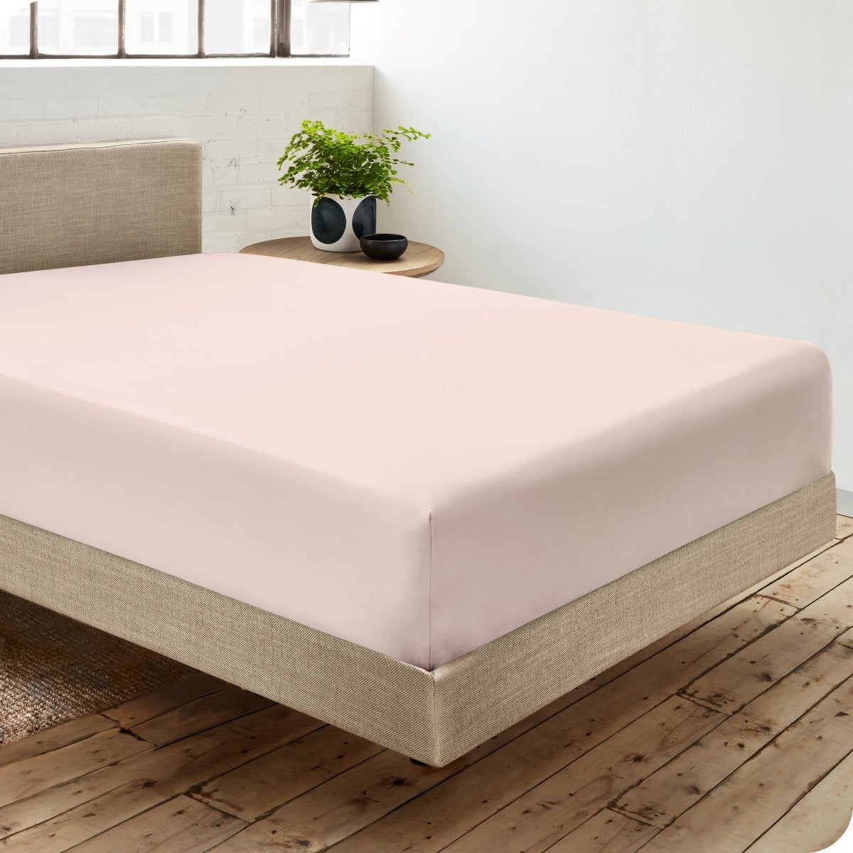 Diagonal view of room scene with percale fitted sheet on the bed