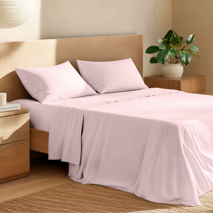 Bed with percale bedding and wooden headboard in a bedroom setting