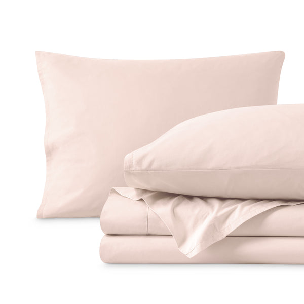 Percale sheets folded and matching pillowcases with pillows in them
