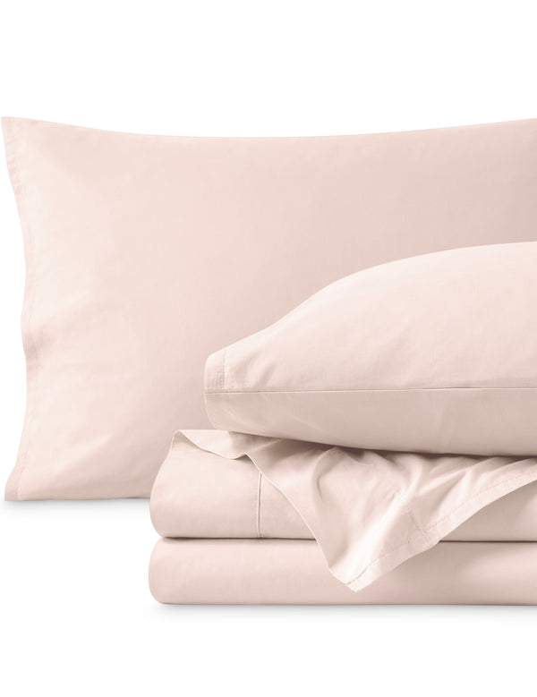 Percale sheets folded and matching pillowcases with pillows in them