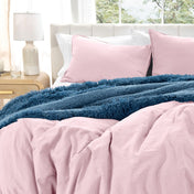 Washed duvet cover set on a bed with pillows and a lamp in the background