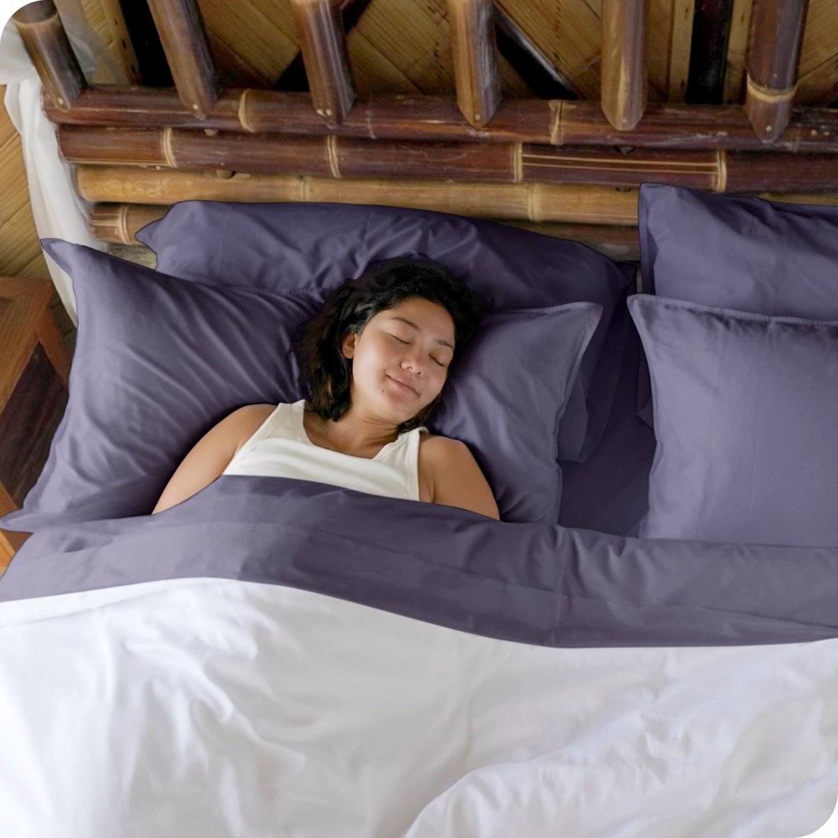 A woman sleeping in a bed made with bamboo sheets