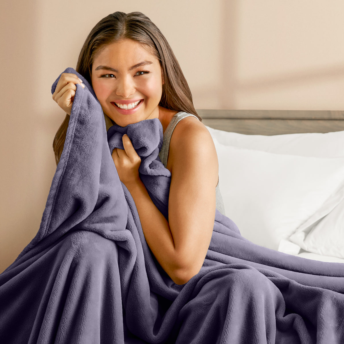 A woman cuddling with a microplush blanket