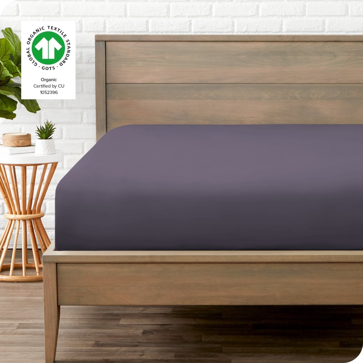 Modern wood bed frame with a sateen fitted sheet on the mattress