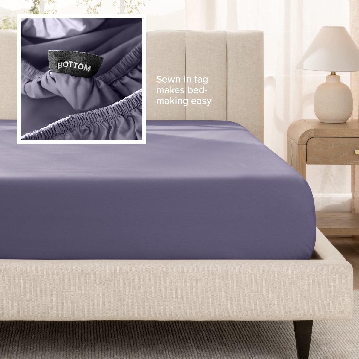 Sateen fitted sheet on a bed with a close-up of a sewn-in tag, set in a bedroom.